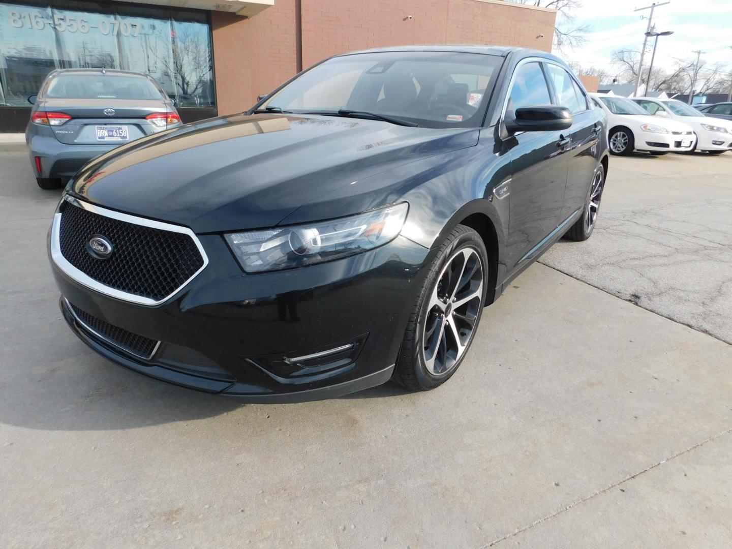 2015 BLACK Ford Taurus SHO AWD (1FAHP2KTXFG) with an 3.5L V6 DOHC 24V engine, 6-Speed Automatic transmission, located at 2121 Burlington St, North Kansas City, MO, 64116, (816) 556-0707, 39.144707, -94.581978 - Photo#0